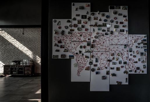 Bangkok, Thailand - 15 Dec 2019 : Refrigerator magnets from different cities of the world on whiteboard in loft style home.