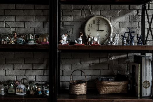 Bangkok, Thailand - 15 Dec 2019 : Souvenir and collectible objects from different cities of the world on books shelf in loft style home, Selective focus.