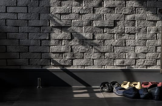 Bangkok, Thailand - 15 Dec 2019 : The sunlight shines on Shoe Holder in loft style home.
