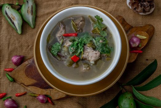 Pork spare rip Madan soup (Kra Dook Moo Tom Ma-Dun) in a white bowl, Traditional Thai food, Top view.