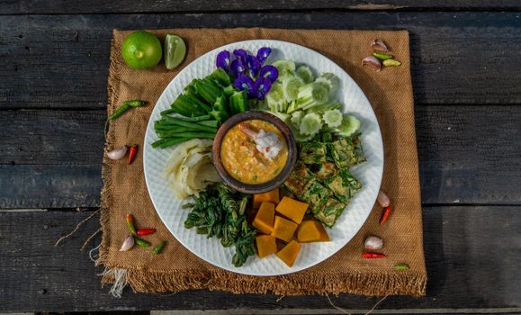 Thai Traditional Local Food : Shrimps chili dip or nam prik with shrimps (Nam Prik Goong Sod) with blanched vegetables and cha-om omelets.