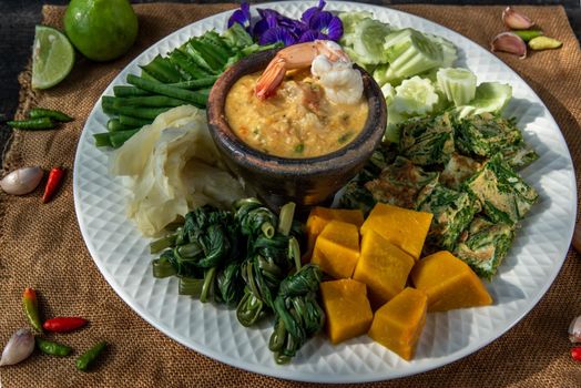 Thai Traditional Local Food : Shrimps chili dip or nam prik with shrimps (Nam Prik Goong Sod) with blanched vegetables and cha-om omelets.
