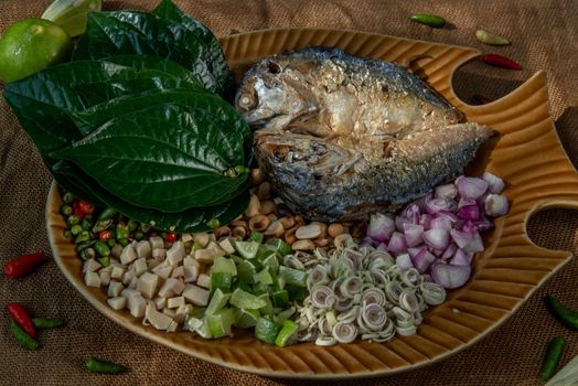 Thai Traditional Food : Fried mackerel served with fresh vegetable and herb, This food is thai food call Meuang Mackerel (Maing-Pla-too) menu.