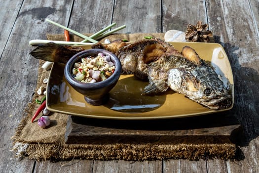 Deep fried whole Snakehead with spicy lemongrass salad, Thai food for health.