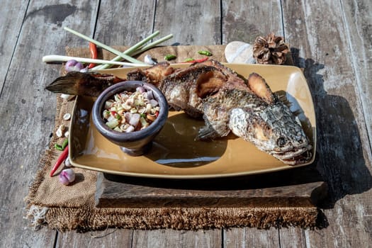 Deep fried whole Snakehead with spicy lemongrass salad, Thai food for health.