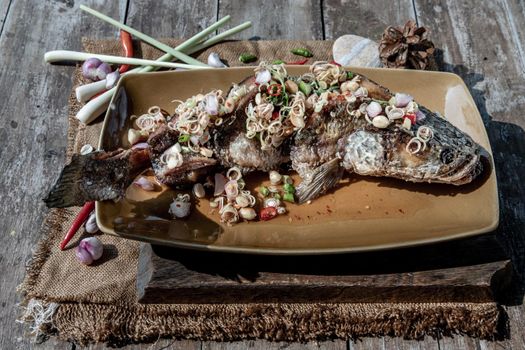 Deep fried whole Snakehead with spicy lemongrass salad, Thai food for health.
