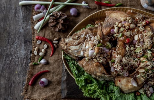 Deep fried whole Tubtim fish with spicy lemongrass salad, Thai food for health.