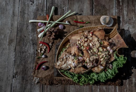 Deep fried whole Tubtim fish with spicy lemongrass salad, Thai food for health.