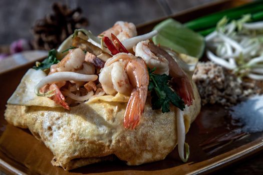 Close-up of Fried Thai Noodle with Shrimp Wrapped in Egg (Pad Thai), That popular food for foreigner tourists.