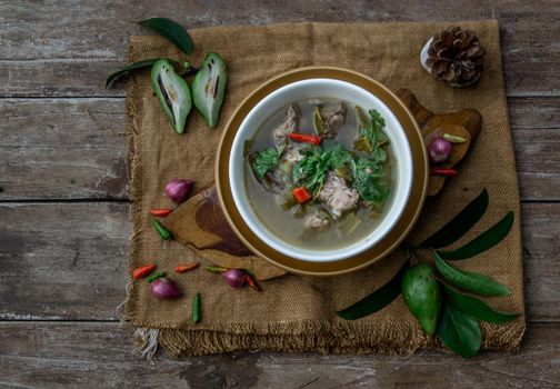 Pork spare rip Madan soup (Kra Dook Moo Tom Ma-Dun) in a white bowl, Traditional Thai food, Top view.