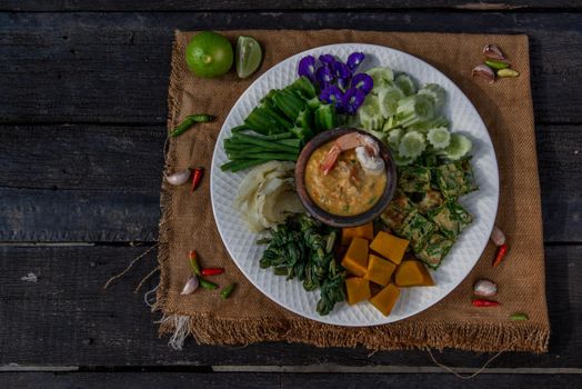 Thai Traditional Local Food : Shrimps chili dip or nam prik with shrimps (Nam Prik Goong Sod) with blanched vegetables and cha-om omelets.