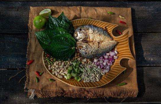 Thai Traditional Food : Fried mackerel served with fresh vegetable and herb, This food is thai food call Meuang Mackerel (Maing-Pla-too) menu.