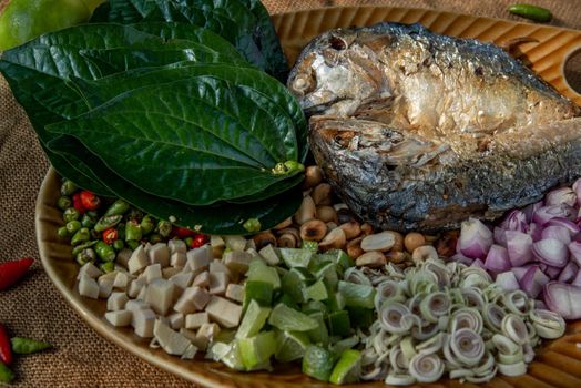 Thai Traditional Food : Fried mackerel served with fresh vegetable and herb, This food is thai food call Meuang Mackerel (Maing-Pla-too) menu.