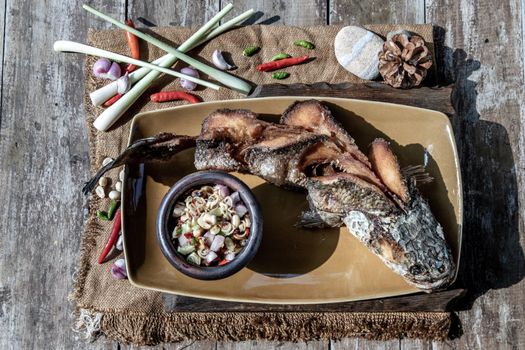 Deep fried whole Snakehead with spicy lemongrass salad, Thai food for health.