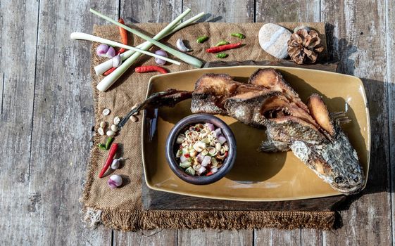 Deep fried whole Snakehead with spicy lemongrass salad, Thai food for health.