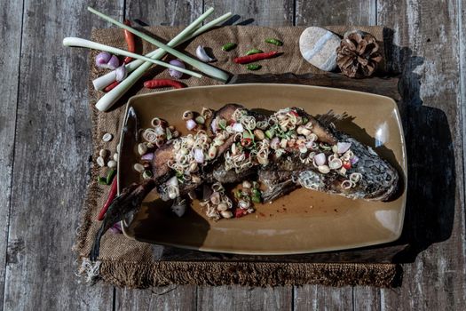 Deep fried whole Snakehead with spicy lemongrass salad, Thai food for health.