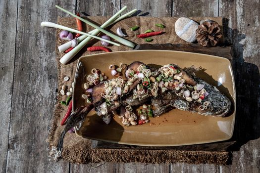Deep fried whole Snakehead with spicy lemongrass salad, Thai food for health.