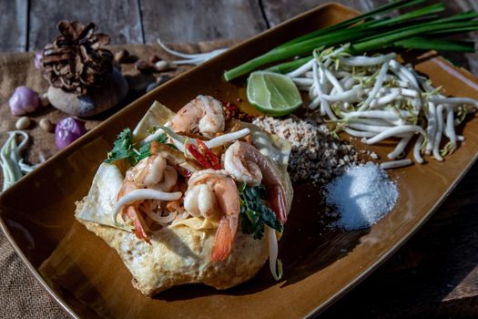 Fried Thai Noodle with Shrimp Wrapped in Egg (Pad Thai), That popular food for foreigner tourists, Oblique view from the top.