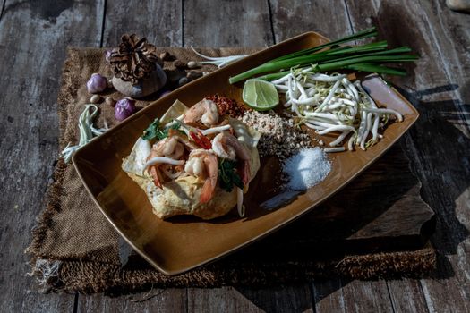 Fried Thai Noodle with Shrimp Wrapped in Egg (Pad Thai), That popular food for foreigner tourists, Oblique view from the top.