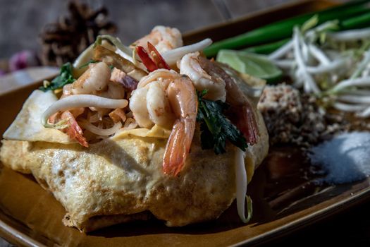 Close-up of Fried Thai Noodle with Shrimp Wrapped in Egg (Pad Thai), That popular food for foreigner tourists.