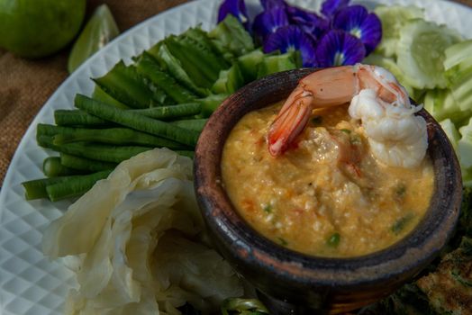 Thai Traditional Local Food : Shrimps chili dip or nam prik with shrimps (Nam Prik Goong Sod) with blanched vegetables and cha-om omelets.