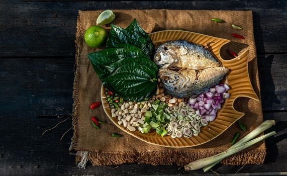 Thai Traditional Food : Fried mackerel served with fresh vegetable and herb, This food is thai food call Meuang Mackerel (Maing-Pla-too) menu.
