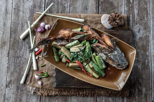 Deep fried whole Snakehead with Spicy stir fry eggplant, Thai food for health.