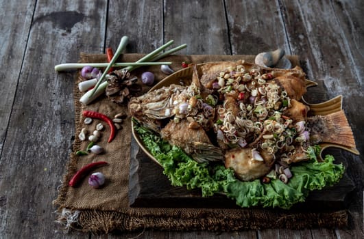 Deep fried whole Tubtim fish with spicy lemongrass salad, Thai food for health.