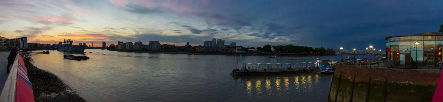 Panoramic view of Canary Wharf and the river Thames at sunset on a sunny summer evening