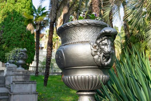 Sochi, Russia. Avenue of the arboretum with vases and trees.