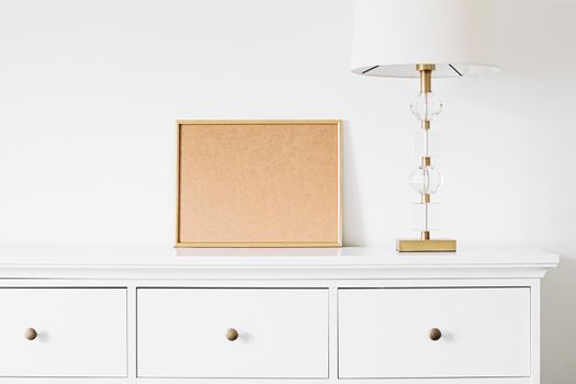 Golden horizontal frame for art, poster or photo in white interior, home decor concept