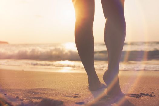 Woman feet walk slow life and relax on sand tropical beach with blue sky background.