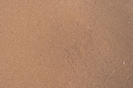 Top view of sand and sea water splash with copy space at tropical clean summer beach.