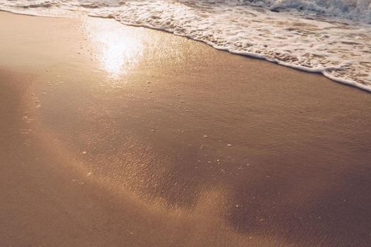 Top view of sand and sea water splash with copy space at tropical clean summer beach.