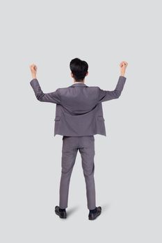 Portrait businessman in suit standing with win success isolated on white background, young asian business man is manager or executive having confident and excited, expression and emotion, back view.