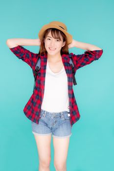 Beautiful portrait young asian woman holding hat smile expression cheerful and enjoy travel summer trip holiday in vacation isolated blue background, tourist happy asia girl confident and excited.