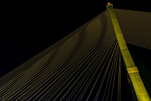 Bangkok, thailand - Nov 23, 2019 : The Rama VIII Bridge is a cable-stayed bridge crossing the Chao Phraya River at night in Bangkok, Thailand
