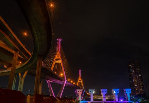 Samutprakan, thailand -  jun, 2019 : Bhumibol Bridge also casually call as Industrial Ring Road Bridge with floodgate illuminate with spotlight at night scene, Samut Prakarn, Thailand
