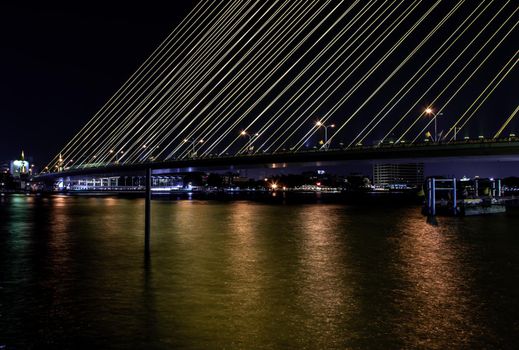 Bangkok, thailand - Nov 23, 2019 : The Rama VIII Bridge is a cable-stayed bridge crossing the Chao Phraya River at night in Bangkok, Thailand