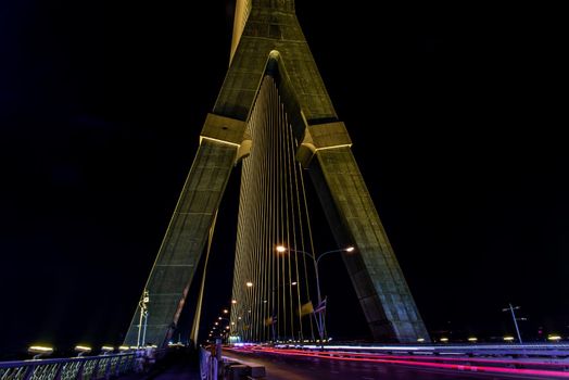 Bangkok, thailand - Nov 23, 2019 : Night sky at road on Rama VIII Bridge with car trails at twilight time in Bangkok, Thailand
