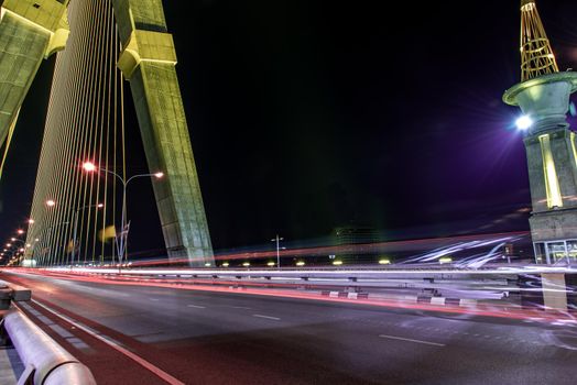 Bangkok, thailand - Nov 23, 2019 : Night sky at road on Rama VIII Bridge with car trails at twilight time in Bangkok, Thailand
