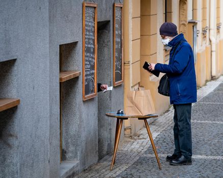 PRAGUE - 24.02.2021, dispense food through the window during the coronavirus lockdown time.
