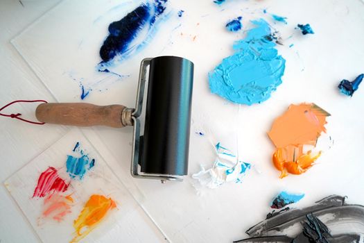 Detail of paint brushes and bright paint in an artist’s studio