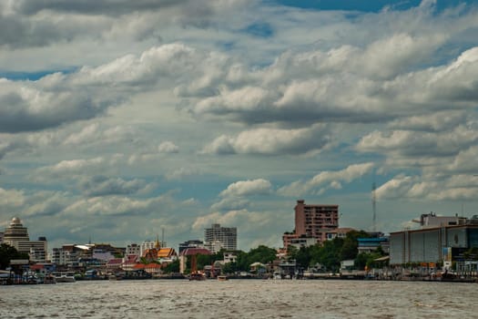 Bangkok, Thailand - 21 Jul 2019 : A view of the bank of Bangkok's Chao Phraya River showing the several tall buildings in the beautiful skyline.