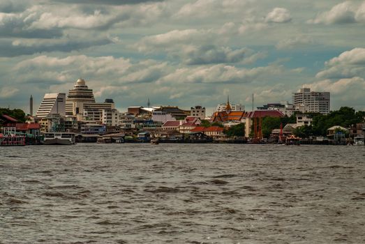 Bangkok, Thailand - 21 Jul 2019 : A view of the bank of Bangkok's Chao Phraya River showing the several tall buildings in the beautiful skyline.