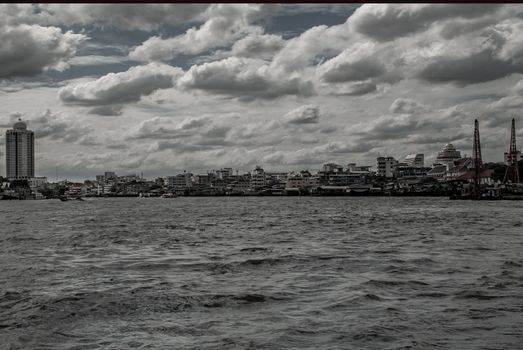 Bangkok, Thailand - 21 Jul 2019 : A view of the bank of Bangkok's Chao Phraya River showing the several tall buildings in the beautiful skyline.