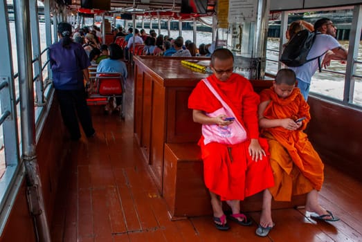 Bangkok, thailand 21 Jul, 2019 : The monks and novices are watching mobile messages during the Chao Phraya Express Boat Ride.