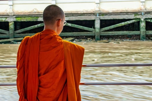 Bangkok, thailand 21 Jul, 2019 : The monks stood on the Chao Phraya Express Boat to travel by water to the temple.