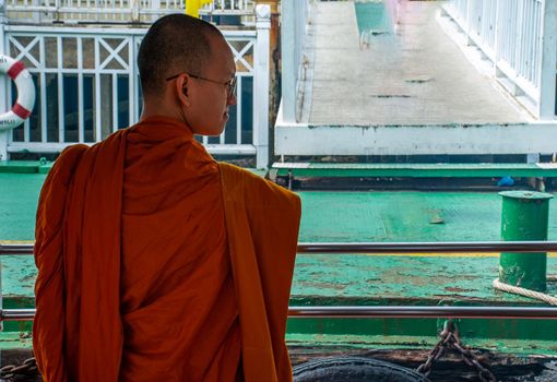 Bangkok, thailand 21 Jul, 2019 : The monks stood on the Chao Phraya Express Boat to travel by water to the temple.