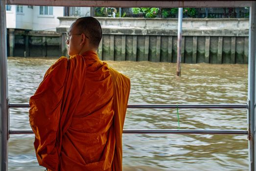 Bangkok, thailand 21 Jul, 2019 : The monks stood on the Chao Phraya Express Boat to travel by water to the temple.
